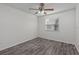 Bedroom featuring neutral walls, gray wood floors, ceiling fan and bright window at 152 Chelsea Ct, Dunedin, FL 34698