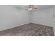 A bright bedroom featuring gray wood floors and natural light at 152 Chelsea Ct, Dunedin, FL 34698