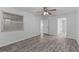 Bedroom with gray wood floors, ceiling fan, neutral walls and bright natural light at 152 Chelsea Ct, Dunedin, FL 34698