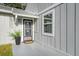 Charming home featuring a modern front door, an inviting entryway, and light gray exterior paint at 152 Chelsea Ct, Dunedin, FL 34698