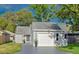 Charming single-story home with an attached garage and well-maintained lawn at 152 Chelsea Ct, Dunedin, FL 34698