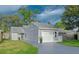 Charming home with a well-manicured front yard and a one car garage at 152 Chelsea Ct, Dunedin, FL 34698