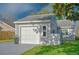 Home featuring an attached one-car garage and a small, well-kept lawn at 152 Chelsea Ct, Dunedin, FL 34698