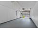 Spacious garage with gray epoxy flooring and an open garage door at 152 Chelsea Ct, Dunedin, FL 34698