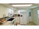 Well-equipped kitchen with white cabinetry, modern appliances, and a functional layout at 152 Chelsea Ct, Dunedin, FL 34698