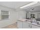 Kitchen featuring sleek countertops, a window, and modern stainless steel appliances at 152 Chelsea Ct, Dunedin, FL 34698