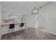 Open-concept kitchen with a breakfast bar, stylish lighting, and modern appliances at 152 Chelsea Ct, Dunedin, FL 34698