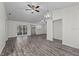 Spacious living room featuring hardwood floors with a sliding glass door leading to the outside at 152 Chelsea Ct, Dunedin, FL 34698