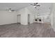 Spacious living room with ceiling fans and hardwood flooring leading to the kitchen at 152 Chelsea Ct, Dunedin, FL 34698