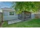 Rear exterior of home with screened-in porch, backyard, and lush green grass at 152 Chelsea Ct, Dunedin, FL 34698