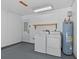 Utility room featuring washer, dryer, and water heater at 152 Chelsea Ct, Dunedin, FL 34698