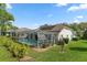 A tranquil backyard with a screened-in pool and well-maintained landscaping provides a private retreat at 2309 Terrace View Ln, Spring Hill, FL 34606
