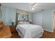 Bedroom with a ceiling fan and floral window coverings at 2309 Terrace View Ln, Spring Hill, FL 34606