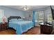Cozy bedroom featuring a plush bed, wood floors, and a window with natural light at 2309 Terrace View Ln, Spring Hill, FL 34606