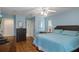 Comfortable bedroom featuring hardwood floors, calming paint color, and ample natural light at 2309 Terrace View Ln, Spring Hill, FL 34606
