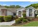 Attractive front entrance with beautiful landscaping, creating a welcoming atmosphere at 2309 Terrace View Ln, Spring Hill, FL 34606