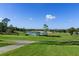 Lush green golf course featuring a tranquil lake and manicured landscape at 2309 Terrace View Ln, Spring Hill, FL 34606