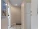 Neutral hallway featuring tile floors, storage, and an entrance to the laundry room at 2309 Terrace View Ln, Spring Hill, FL 34606