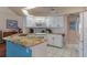 Charming kitchen featuring white appliances, cabinets, and a granite countertop island with bar seating at 2309 Terrace View Ln, Spring Hill, FL 34606