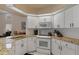 Kitchen features granite countertops, white cabinets, and stainless steel oven and microwave at 2309 Terrace View Ln, Spring Hill, FL 34606