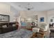 Spacious living room with a ceiling fan, hardwood floors, and open floor plan to the kitchen at 2309 Terrace View Ln, Spring Hill, FL 34606
