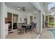 Covered patio with dining table, chairs, and access to the pool area at 2309 Terrace View Ln, Spring Hill, FL 34606