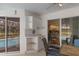 Covered patio with built-in cabinets and a view of the pool and kitchen at 2309 Terrace View Ln, Spring Hill, FL 34606