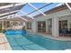 Backyard swimming pool with an enclosure, and view of screened patio, outdoor seating, and home exterior at 2309 Terrace View Ln, Spring Hill, FL 34606