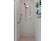 Clean and accessible walk-in shower with grab bars and built-in shelving at 2309 Terrace View Ln, Spring Hill, FL 34606