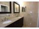 Elegant bathroom with dual sinks, granite countertops, and framed mirrors at 23310 Cascade Pl, Land O Lakes, FL 34639