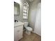 Clean bathroom with a toilet, and a vanity with a sink and window at 23310 Cascade Pl, Land O Lakes, FL 34639