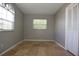 Well-lit bedroom with travertine floors and a window at 23310 Cascade Pl, Land O Lakes, FL 34639