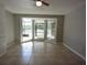 Bright dining room with tile floors and sliding door access to screened-in patio with lake view at 23310 Cascade Pl, Land O Lakes, FL 34639