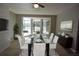 Formal dining room with seating for six and sliding door access to screened-in patio and lake view at 23310 Cascade Pl, Land O Lakes, FL 34639