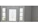 Bright entryway featuring a white front door with decorative glass and sidelights at 23310 Cascade Pl, Land O Lakes, FL 34639