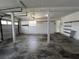 Spacious garage is unfinished, white walls, and a concrete floor at 23310 Cascade Pl, Land O Lakes, FL 34639