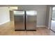 Bright kitchen showcasing stainless steel refrigerators and ceramic tile flooring at 23310 Cascade Pl, Land O Lakes, FL 34639