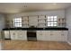 Well-lit kitchen with stainless steel appliances, granite countertops, and open shelving at 23310 Cascade Pl, Land O Lakes, FL 34639
