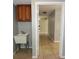 Functional laundry room features a utility sink, wooden cabinets, and neutral-toned walls and floors at 23310 Cascade Pl, Land O Lakes, FL 34639