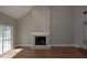 Bright living room featuring a fireplace, vaulted ceilings, and wood-look flooring at 23310 Cascade Pl, Land O Lakes, FL 34639