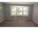 Bright living room featuring a bay window with natural light and neutral carpeting at 23310 Cascade Pl, Land O Lakes, FL 34639