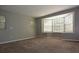 Large living room boasting neutral paint, carpet, and bay windows bringing in natural light at 23310 Cascade Pl, Land O Lakes, FL 34639