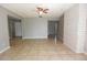 Open living room features neutral paint, ceramic tile flooring, and a ceiling fan at 23310 Cascade Pl, Land O Lakes, FL 34639
