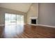 Spacious living room with hardwood floors, a fireplace, and sliding glass doors leading to the backyard at 23310 Cascade Pl, Land O Lakes, FL 34639