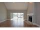 Spacious living room with hardwood floors, a fireplace, and sliding glass doors leading to the backyard at 23310 Cascade Pl, Land O Lakes, FL 34639
