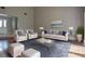 An open living room with high ceilings features a stylish sitting arrangement with matching armchairs and sofas at 23310 Cascade Pl, Land O Lakes, FL 34639