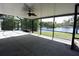 Large screened in patio overlooking a serene lake, perfect for relaxing and entertaining at 23310 Cascade Pl, Land O Lakes, FL 34639