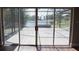 Sliding doors lead to screened-in patio with views of the lake at 23310 Cascade Pl, Land O Lakes, FL 34639