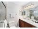 Bathroom with a granite countertop, a cherry wood vanity and a glass enclosed shower at 290 Winchester Way, Palm Harbor, FL 34684