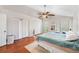 Bedroom with hardwood floors, ceiling fan, and double closets at 290 Winchester Way, Palm Harbor, FL 34684